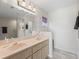Bathroom with a double vanity, sink, and a well-lit mirror at 17504 Se 119Th Cir, Summerfield, FL 34491