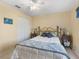 Bedroom showcasing a gold bed frame, white closet doors, and coordinated side tables with lamps at 17504 Se 119Th Cir, Summerfield, FL 34491