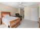 Sunlit bedroom featuring a cozy recliner chair, soft carpet, and ample closet space at 17504 Se 119Th Cir, Summerfield, FL 34491