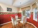 Eat-in kitchen nook with glass table set, bright lighting, and a window with a view at 17504 Se 119Th Cir, Summerfield, FL 34491