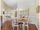 Dining room with wood floors, a chandelier, and views into the kitchen and living spaces at 17504 Se 119Th Cir, Summerfield, FL 34491