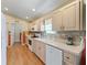 Well-lit kitchen featuring tile backsplash, ample counter space, and modern appliances at 17504 Se 119Th Cir, Summerfield, FL 34491