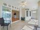 Sunroom with tile flooring, ceiling fan, and sliding glass doors that provide plenty of natural light at 17504 Se 119Th Cir, Summerfield, FL 34491