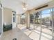 Bright sunroom with tile floors, ceiling fan and large sliding doors at 17504 Se 119Th Cir, Summerfield, FL 34491