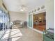 Tiled sunroom with sliding glass doors to the outside and furniture at 17504 Se 119Th Cir, Summerfield, FL 34491