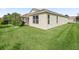 Spacious backyard with green lawn, ideal for outdoor activities and relaxation, with screened patio in view at 1904 Augustine Dr, The Villages, FL 32159