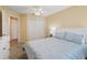 Comfortable bedroom with blue bedding, a ceiling fan, and a closet at 1904 Augustine Dr, The Villages, FL 32159