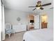 Bright bedroom with a ceiling fan, a white dresser, and an ensuite bathroom at 1904 Augustine Dr, The Villages, FL 32159