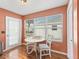 Bright breakfast nook with a white table and chairs, as well as, a window with natural light at 1904 Augustine Dr, The Villages, FL 32159
