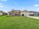 Well-maintained single-Gathering home with a green lawn, a two-car garage, and manicured landscaping at 1904 Augustine Dr, The Villages, FL 32159