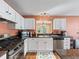 Well-equipped kitchen featuring stainless steel appliances, granite countertops, and white cabinetry at 1904 Augustine Dr, The Villages, FL 32159