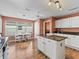 Spacious kitchen with an island, hardwood floors, and stainless steel appliances, with a cozy breakfast nook at 1904 Augustine Dr, The Villages, FL 32159