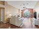Sun-filled living room with vaulted ceilings, hardwood floors, a large window, and neutral decor at 1904 Augustine Dr, The Villages, FL 32159