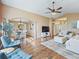 Open-concept living room with hardwood floors, neutral furnishings, and ample natural light at 1904 Augustine Dr, The Villages, FL 32159