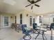 Relaxing covered patio includes ceiling fan, and comfortable seating, perfect for outdoor enjoyment at 1904 Augustine Dr, The Villages, FL 32159