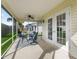 Screened patio with ceiling fan, offers serene outdoor living and protection from insects at 1904 Augustine Dr, The Villages, FL 32159