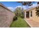 Backyard featuring manicured hedges and a screened in porch at 1938 Sassparilla Way, The Villages, FL 32162