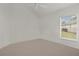 A well-lit bedroom with a view from the window at 1938 Sassparilla Way, The Villages, FL 32162