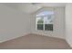 Bright bedroom with a large window offering natural light and scenic views at 1938 Sassparilla Way, The Villages, FL 32162