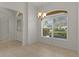 Inviting dining area featuring tile flooring, an elegant chandelier, and a large window for natural light at 1938 Sassparilla Way, The Villages, FL 32162
