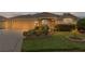 Charming single-story home featuring a two-car garage and beautifully landscaped front yard at 1938 Sassparilla Way, The Villages, FL 32162
