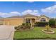 Well-maintained single-story home with a two-car garage and manicured lawn at 1938 Sassparilla Way, The Villages, FL 32162