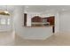 A stunning open concept featuring a kitchen with island and stainless appliances at 1938 Sassparilla Way, The Villages, FL 32162