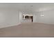 A carpeted living room featuring an open floor plan and kitchen view at 1938 Sassparilla Way, The Villages, FL 32162