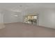 Spacious living room with a sliding glass door to a patio and a ceiling fan at 1938 Sassparilla Way, The Villages, FL 32162