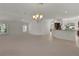 Spacious living room with views into the kitchen area and ample natural lighting at 1938 Sassparilla Way, The Villages, FL 32162
