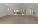 Expansive living area featuring a sliding door to the lanai with room to entertain and relax at 1938 Sassparilla Way, The Villages, FL 32162