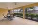 Enclosed patio features neutral walls, ceiling fans, and view of yard with privacy wall at 1938 Sassparilla Way, The Villages, FL 32162