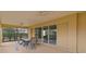 Spacious outdoor patio with ceiling fans, furniture and sliding glass doors to the home at 1938 Sassparilla Way, The Villages, FL 32162