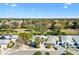 Aerial view of the neighborhood with lush greenery, mature trees, and nearby amenities at 1952 Peachtree Ave, The Villages, FL 32162