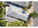 An aerial view shows the home with a covered patio and mature trees at 1952 Peachtree Ave, The Villages, FL 32162