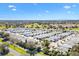 Community aerial view showcases beautiful landscaping, serene environment, and blue skies at 1952 Peachtree Ave, The Villages, FL 32162