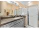 Modern bathroom featuring gray cabinets, a glass-enclosed shower, and a spacious vanity at 1952 Peachtree Ave, The Villages, FL 32162