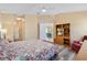 Comfortable bedroom with wood floors, a TV, and a view into the rest of the house at 1952 Peachtree Ave, The Villages, FL 32162