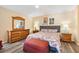 Inviting bedroom with hardwood floors, a cozy bed, and tasteful decor at 1952 Peachtree Ave, The Villages, FL 32162