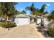Charming home featuring a two-car garage, well-manicured landscaping, and a welcoming entrance at 1952 Peachtree Ave, The Villages, FL 32162