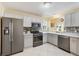 Modern kitchen featuring stainless steel appliances, updated countertops, and ample cabinet space at 1952 Peachtree Ave, The Villages, FL 32162