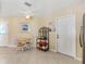 Well-lit eat-in kitchen featuring tile floors and access to appliances and entry door at 1952 Peachtree Ave, The Villages, FL 32162