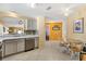 Open kitchen featuring stainless steel appliances, tile flooring, and seamless transition to the dining and living areas at 1952 Peachtree Ave, The Villages, FL 32162
