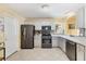 Updated kitchen featuring stainless steel appliances, modern countertops, and a stylish backsplash at 1952 Peachtree Ave, The Villages, FL 32162