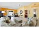 Comfortable living room with neutral tones, tile flooring, and access to an outdoor patio at 1952 Peachtree Ave, The Villages, FL 32162