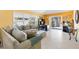 Comfortable living room with a plush sofa, large windows, and access to the patio at 1952 Peachtree Ave, The Villages, FL 32162