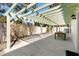 A covered patio has a concrete floor, an outdoor dining set, and access to the home at 1952 Peachtree Ave, The Villages, FL 32162