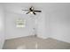 Cozy bedroom with tile flooring, a window, and ceiling fan at 209 Orange Ave, Fort Meade, FL 33841