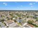 Aerial view showcasing the community's layout, green spaces, and the residential properties within a serene setting at 2116 Baldwin Run, The Villages, FL 32162