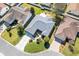 Overhead view of home and the street, showing front yard landscaping, long driveway and street at 2116 Baldwin Run, The Villages, FL 32162